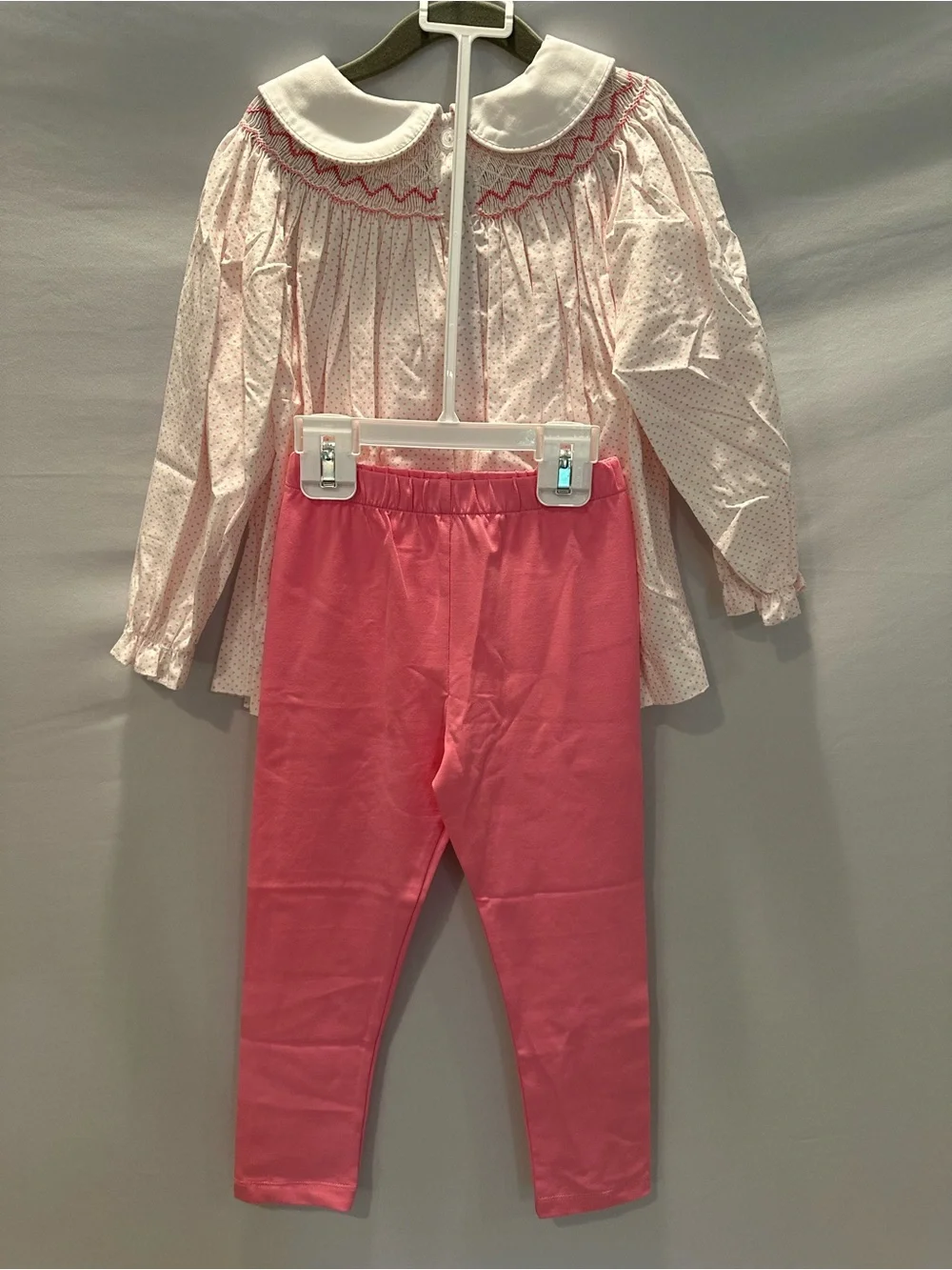 Girls' Pink Smocked Top & Legging Set with Matching Bow.